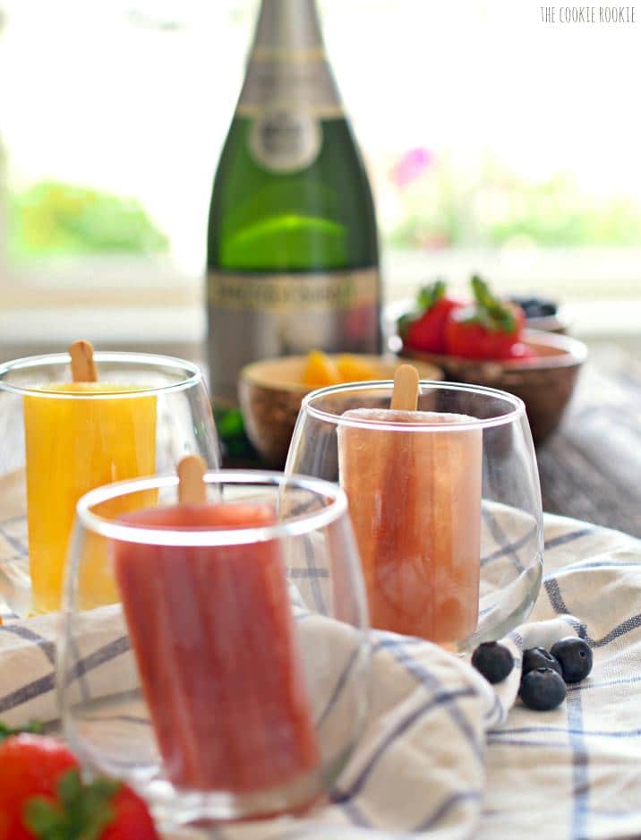 Mimosa Popsicles in Orange, Strawberry, Apple Cider, Blueberry, and Pineapple! So fun and delicious. Mimosa Champagne Pops for adults!